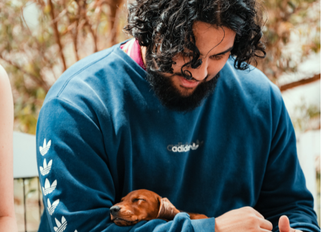 student cuddling a puppy